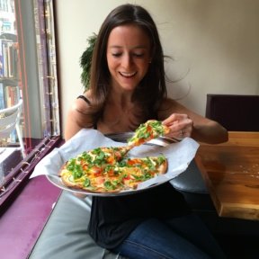 Jackie eating Gluten-free pizza from Pie by the Pound